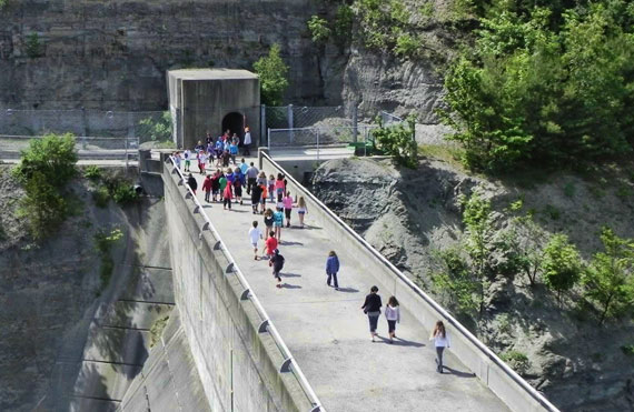School children tour a dam facility, learning both about how water is managed and how hydroelectricity is generated